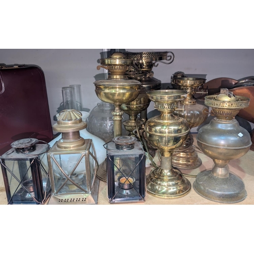 9 - A collection of vintage brass oil lamps and vintage lanterns.