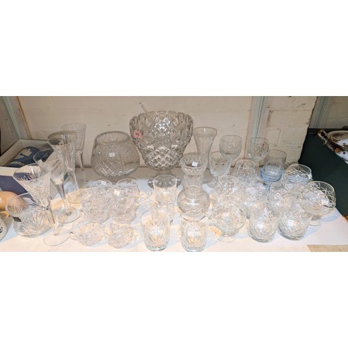 515 - A large cut glass punch bowl and glasses and a selection of wine and brandy glasses.