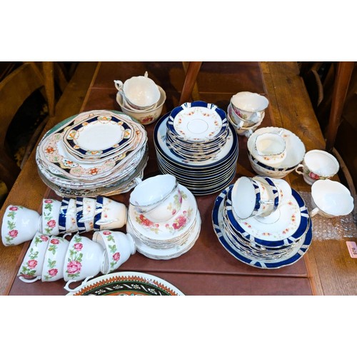 551B - A floral and blue bordered china tea service and other dinner and teaware.