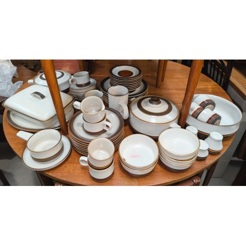 554A - A collection of Denby 'Potters Wheel' to include jugs, lidded serving dishes, salt and pepper etc.