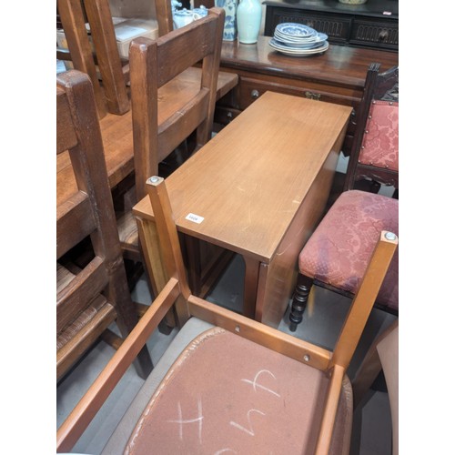 1028 - A mid 20th century teak drop leaf dining table and four chairs