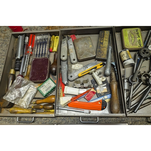 111 - A cabinet containing vintage taps, dies, chisels, files, Stanley knives etc (one drawer missing, one... 