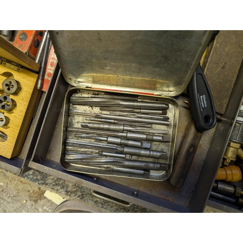 111 - A cabinet containing vintage taps, dies, chisels, files, Stanley knives etc (one drawer missing, one... 