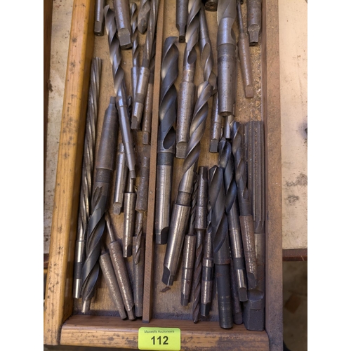 112 - A collection of various large and smaller drill bits, various types and forms.