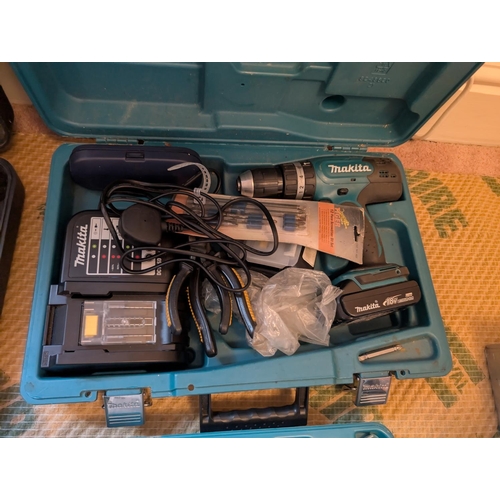 30 - A cased Makita replicating saw and a case Makita drill.