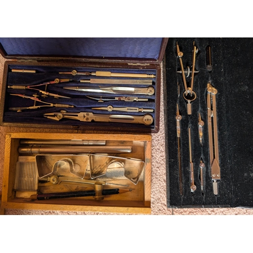 34 - Two cased drawing sets and a set of compasses etc.