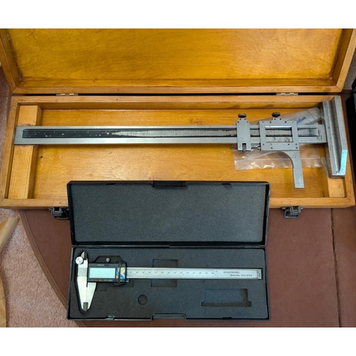 54 - A cased vertical T350 calipers, and a digital calipers.