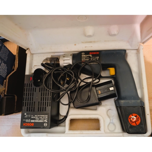 68 - A Bosch tin cased jigsaw 520w and a Bosch drill in case.