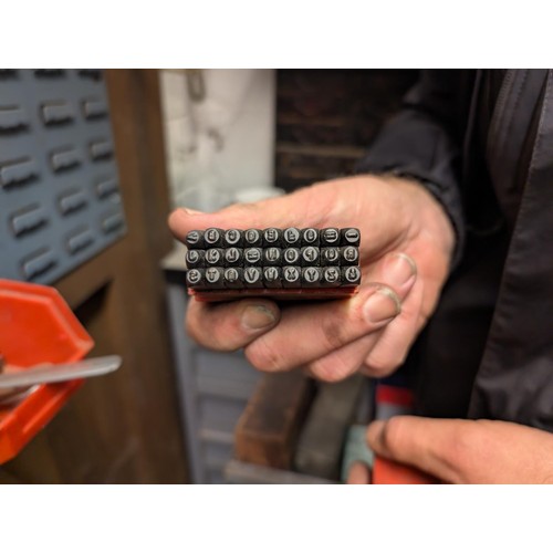 147 - A workshop cabinet containing five sets of letter punches, Stanley plane etc.