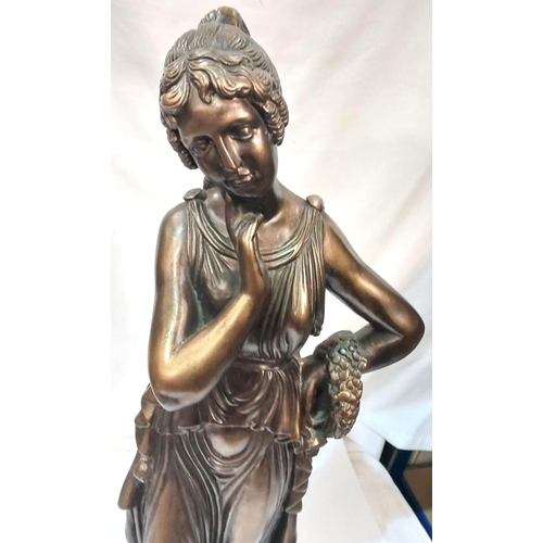 120 - A bronzed statue depicting a young woman in classical dress, ht. 65cm