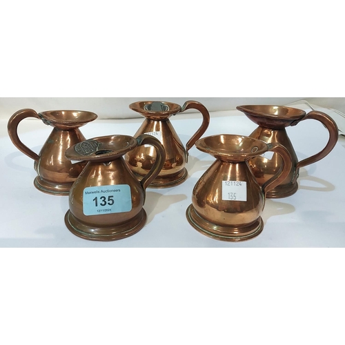 135 - 5 copper jugs, 1/8th gill to 1/2 gill, each with pewter stamps to the rim.