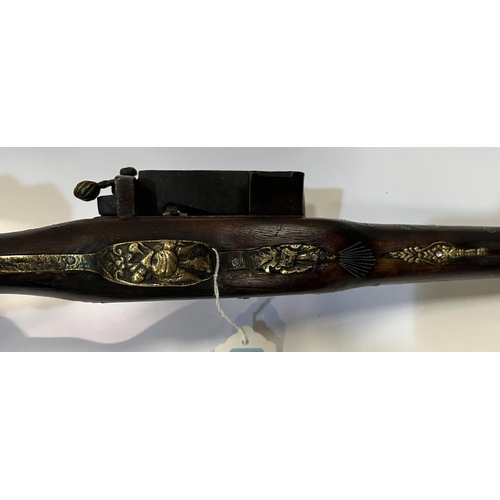 169 - A display flintlock rifle wity older flintlock firing mechanism and inlaid stock, later brass and ot... 