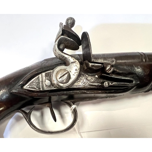 173 - An antique short barrel pistol with later additions, with cocking action, silvered fittings, shaped ... 