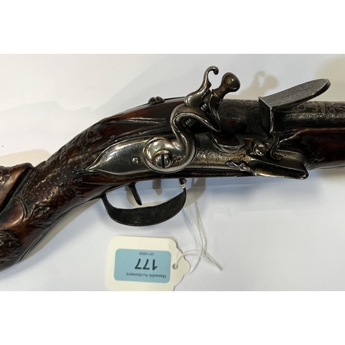 177 - A possibly Turkish long blunderbuss flintlock pistol with silvered barrel, carved and silvered stock... 