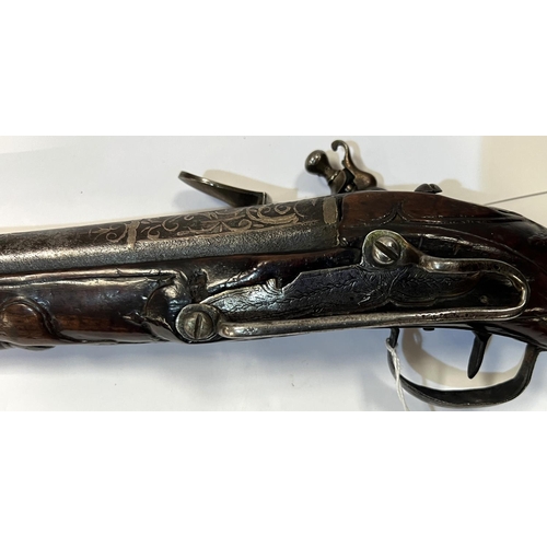 177 - A possibly Turkish long blunderbuss flintlock pistol with silvered barrel, carved and silvered stock... 