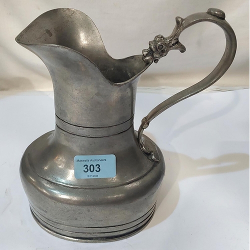 303 - A 19th Century pewter jug with stamps to base and dragon on handle, height 20cm.