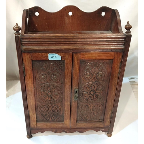 315 - An oak double door smokers cabinet and a selection of plate and metalware.