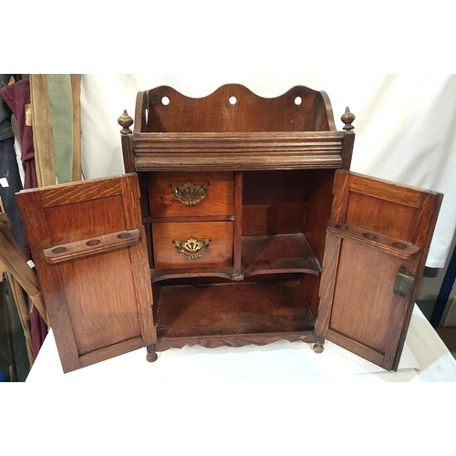 315 - An oak double door smokers cabinet and a selection of plate and metalware.