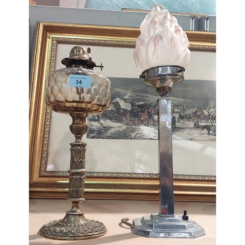 34 - An ornate Victorian brass oil lamp with glass reservoir; an Art Deco chrome table lamp with flame gl... 