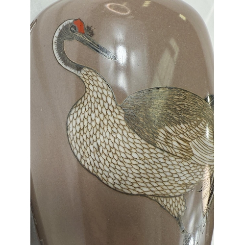 411 - A Japanese Meiji period Cloisonne vase decorated with white metal heron (some cracking and crazing) ... 