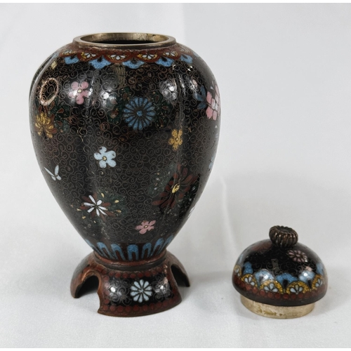 412 - A Japanese Meiji period lobed Cloisonne lidded vase with three feet under, floral decoration. Height... 