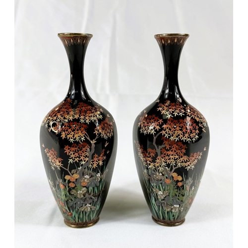 418 - A pair of Japanese Meiji period Cloisonne white metal wired vases with fine detail of trees and flow... 