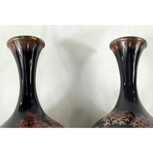 418 - A pair of Japanese Meiji period Cloisonne white metal wired vases with fine detail of trees and flow... 