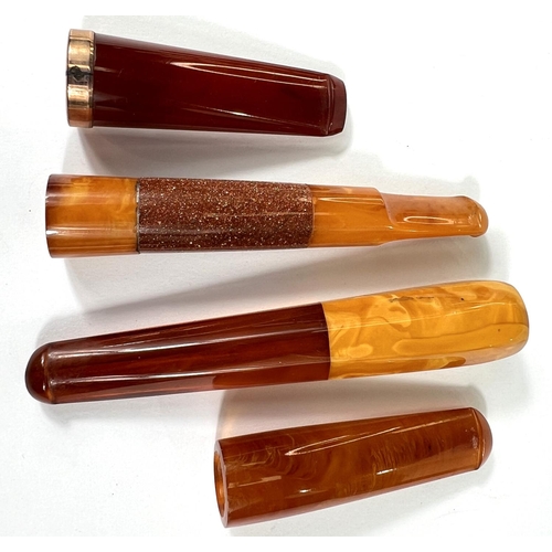 42 - 4 cased amber cigar holders, one with 9 carat mount.