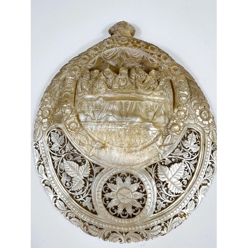 421 - An oriental extensively carved and pierced mother of pearl shell depicting the Last Supper, length 2... 