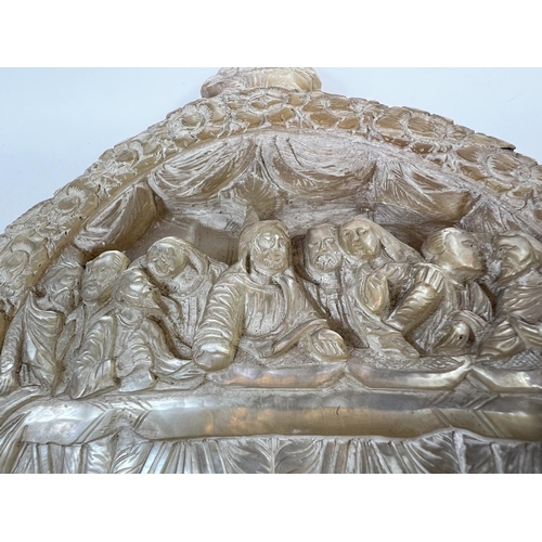 421 - An oriental extensively carved and pierced mother of pearl shell depicting the Last Supper, length 2... 