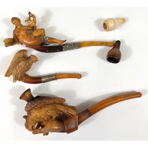 43 - An unusual cased pair of amber and Meerschaum pipes, one depicting a naked woman, the other an eagle... 