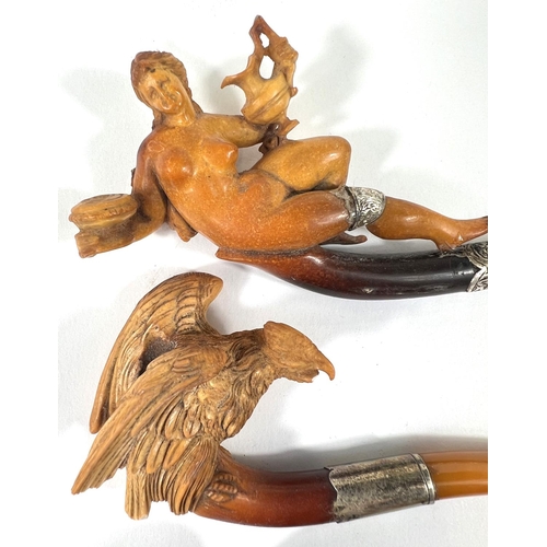 43 - An unusual cased pair of amber and Meerschaum pipes, one depicting a naked woman, the other an eagle... 