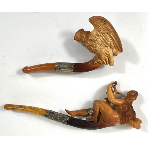 43 - An unusual cased pair of amber and Meerschaum pipes, one depicting a naked woman, the other an eagle... 