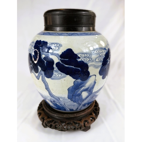 433A - A Chinese blue and white ginger jar on associated stand with wooden decorated with trees and animals... 