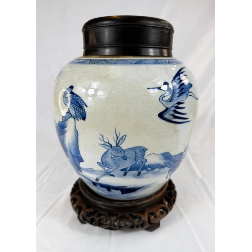 433A - A Chinese blue and white ginger jar on associated stand with wooden decorated with trees and animals... 