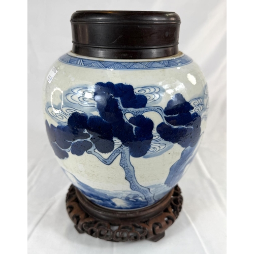 433A - A Chinese blue and white ginger jar on associated stand with wooden decorated with trees and animals... 