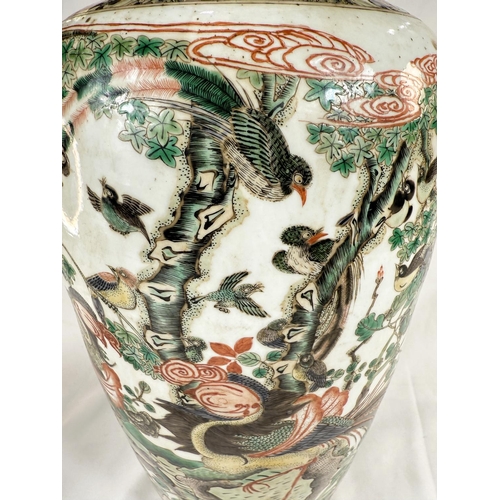 434B - A Chinese Famille Verte vase with polychrome decoration of birds on branches, height 44cm.