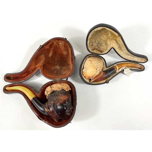 45 - 2 cased amber and Meerschaum pipes depicting black boys heads.