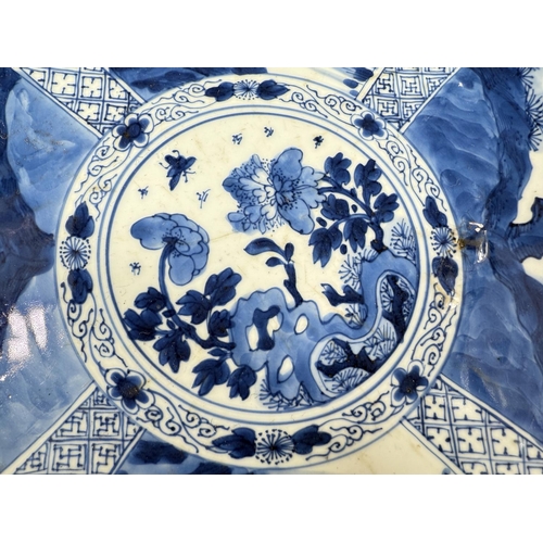 453 - A Chinese Kangxi period blue charger with blue and white decoration of trees and flowers, flower mar... 