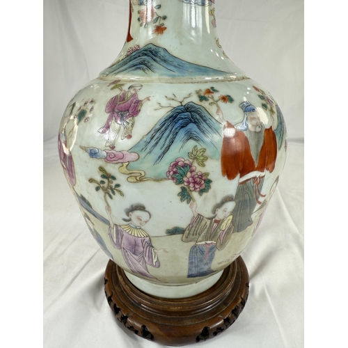 456 - A Chinese Famille Rose vase decorated with polychrome figures of people collecting flowers, with sea... 