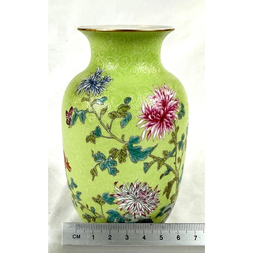 457A - A Chinese lime green vase decorated with polychrome chrysanthemums, incised wave pattern, seal mark ... 