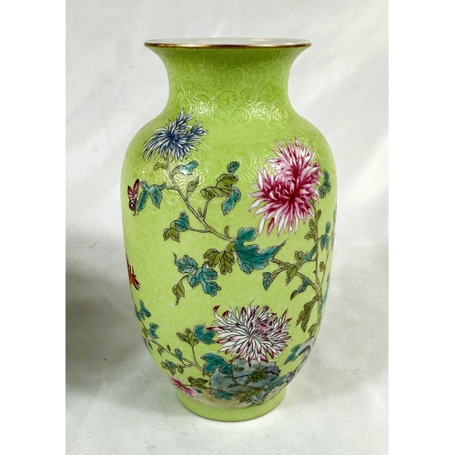 457A - A Chinese lime green vase decorated with polychrome chrysanthemums, incised wave pattern, seal mark ... 