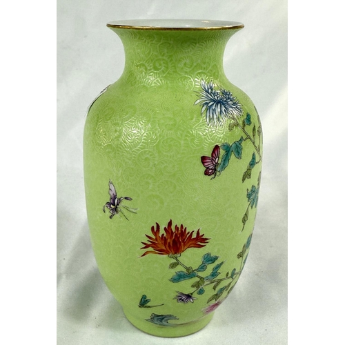 457A - A Chinese lime green vase decorated with polychrome chrysanthemums, incised wave pattern, seal mark ... 