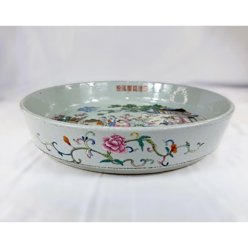 458 - A large and impressive Chinese shallow bowl with polychrome decoration of traditional courtyard scen... 