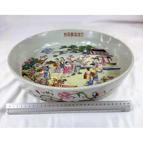 458 - A large and impressive Chinese shallow bowl with polychrome decoration of traditional courtyard scen... 