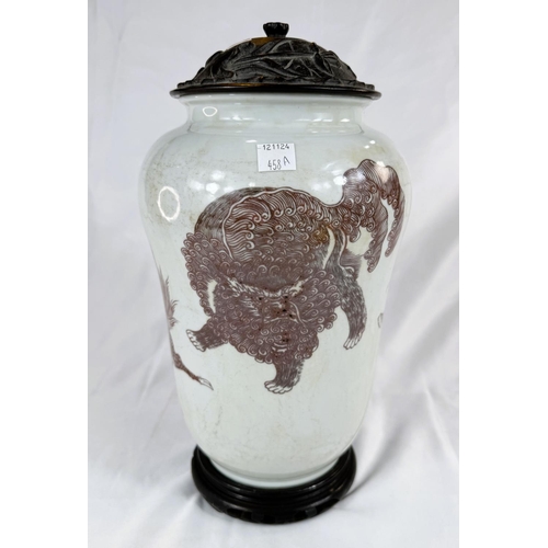 458A - A Chinese white ground vase decorated with mythical and other beasts in red with carved hardwood lid... 