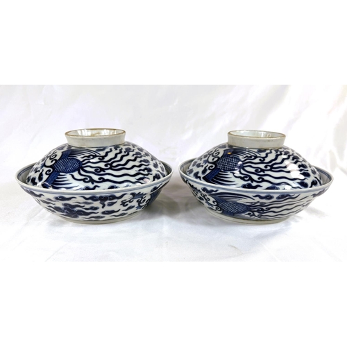 460 - A pair of Chinese blue and white lidded bowls with birds in clouds, six character mark to base and l... 