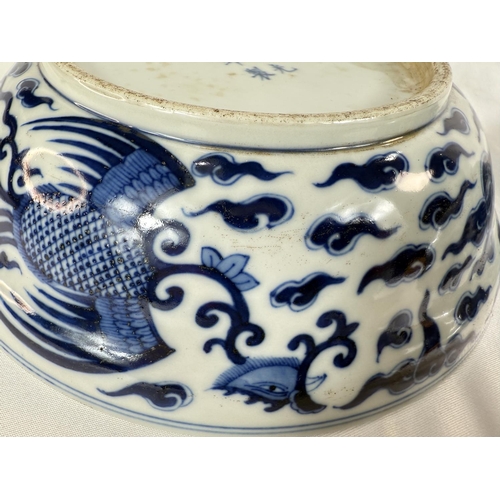 460 - A pair of Chinese blue and white lidded bowls with birds in clouds, six character mark to base and l... 