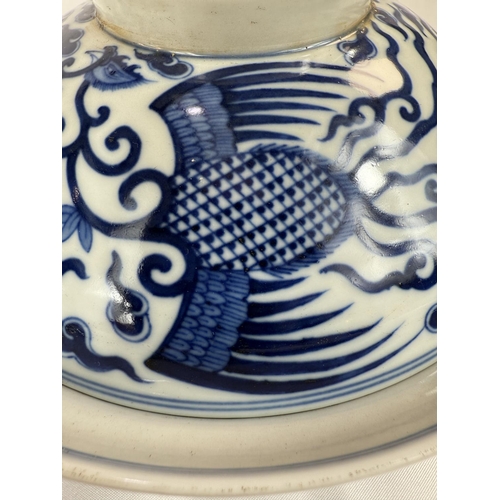 460 - A pair of Chinese blue and white lidded bowls with birds in clouds, six character mark to base and l... 