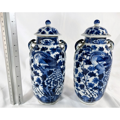 463 - A pair of Chinese 18th/19th Century lidded vases with marks for Kangxi period, blue and white with b... 